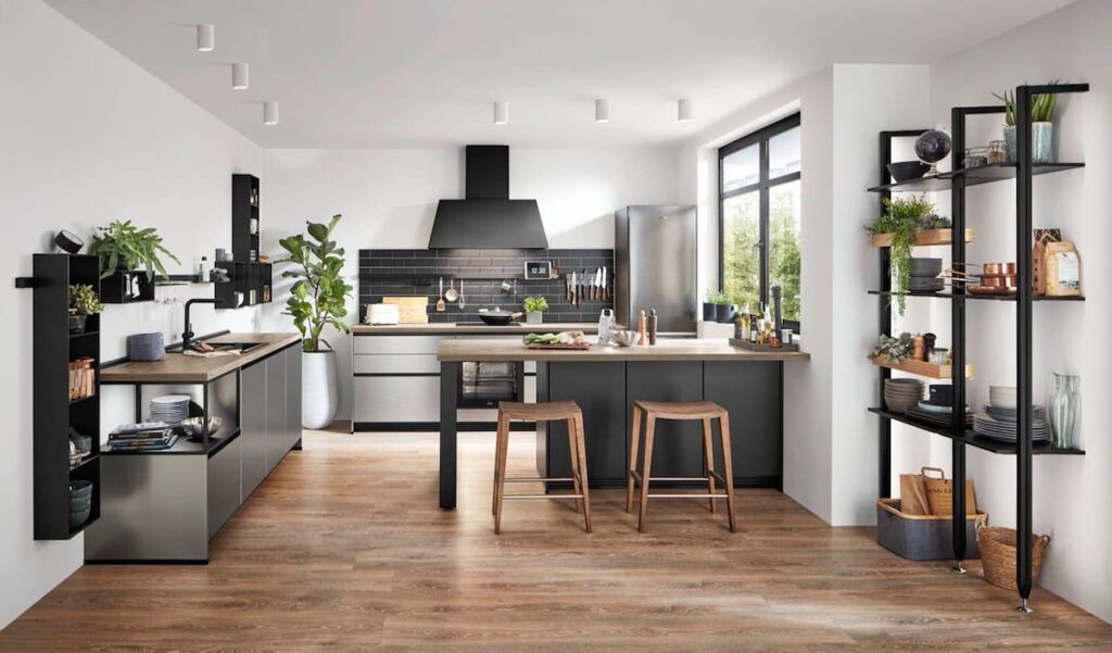 Industrial kitchen interior design featuring dark gray cabinets, open shelving, and a wood-look floor. The mix of materials creates a modern and stylish space.