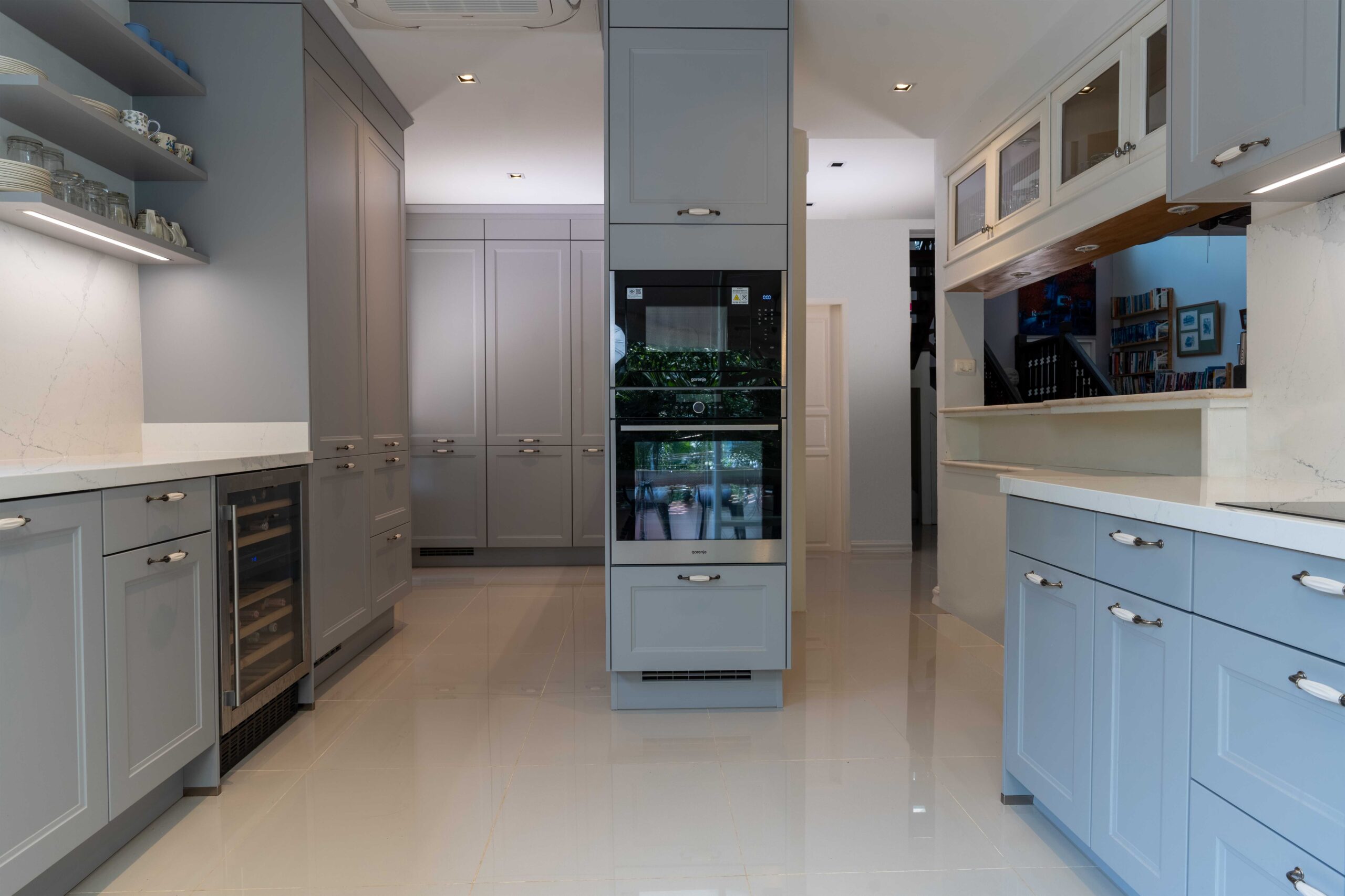 Stone grey kitchen cabinets featuring an integrated wine fridge, blending modern function with cottage kitchen style.