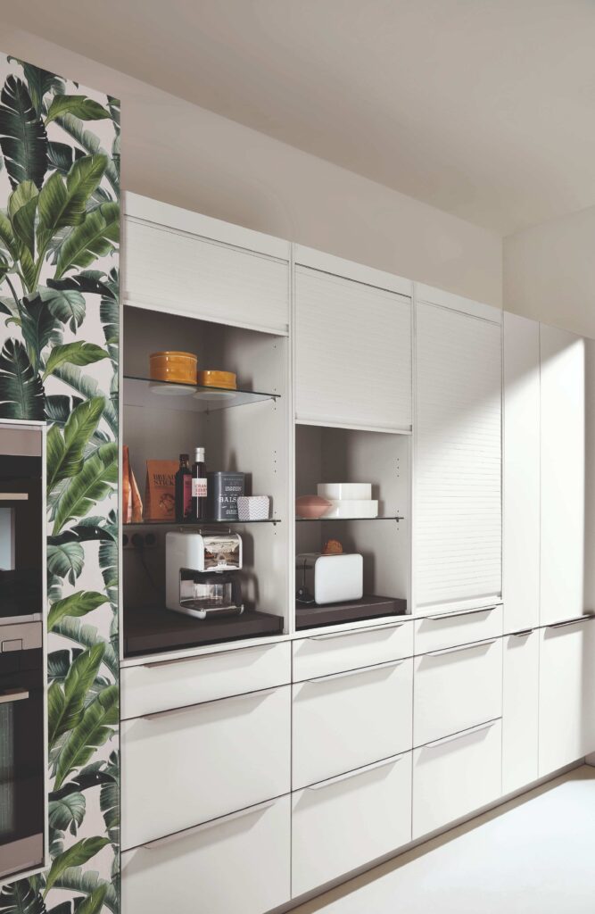 Modern kitchen layout with built-in appliance garages, creating a clean and a bright, minimalist aesthetic.