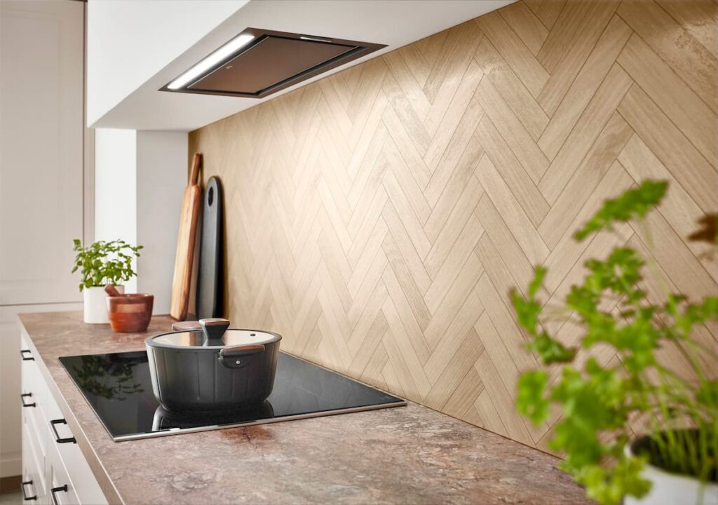 Light herringbone wood backsplash and stone worktop embodying a modern coastal natural living aesthetic.